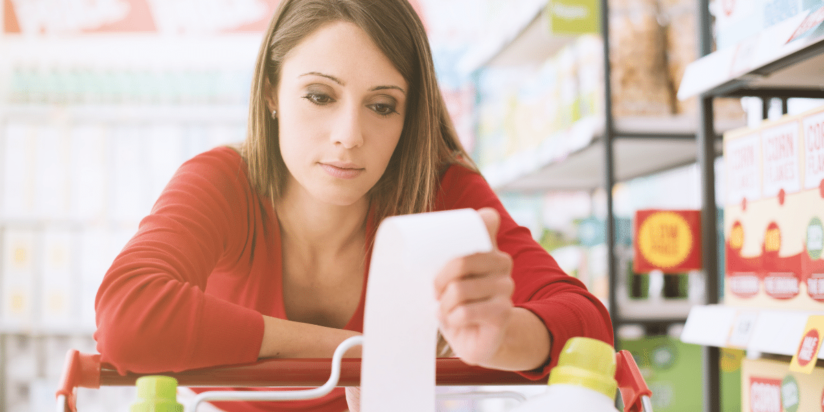 Shopper looking at grocery reciept